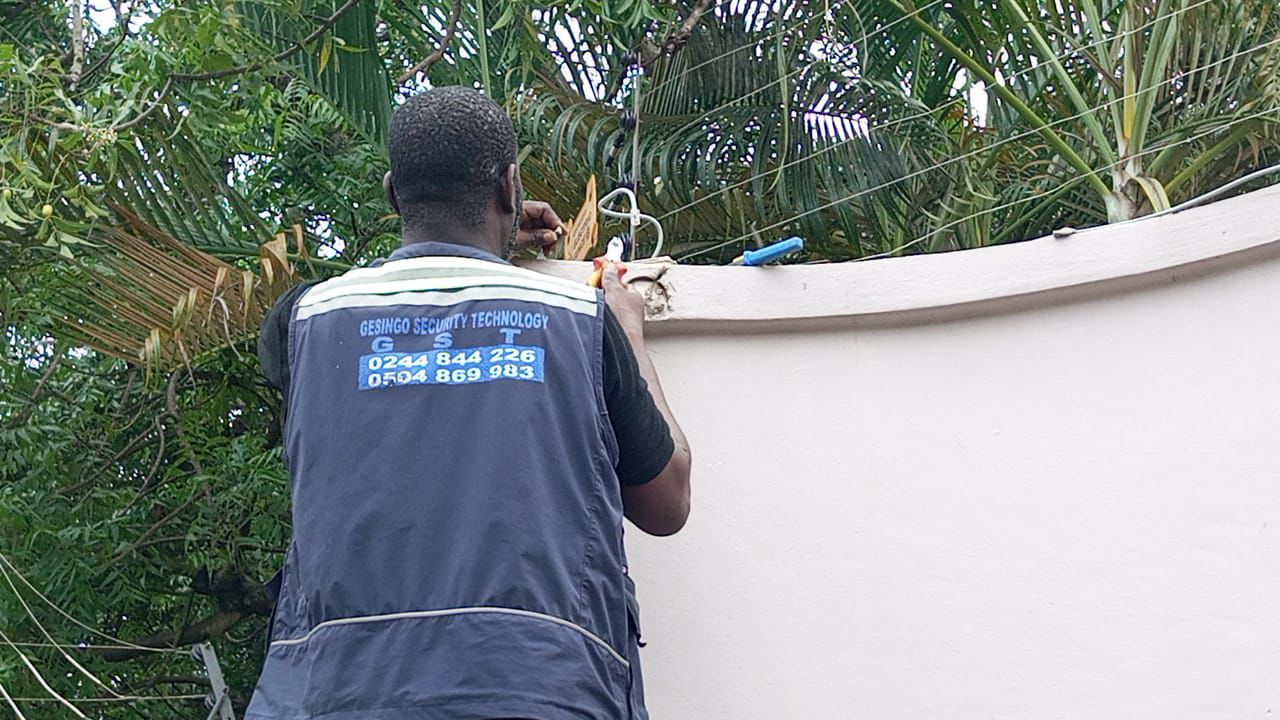 GESINGO technician installing security equipment outdoors